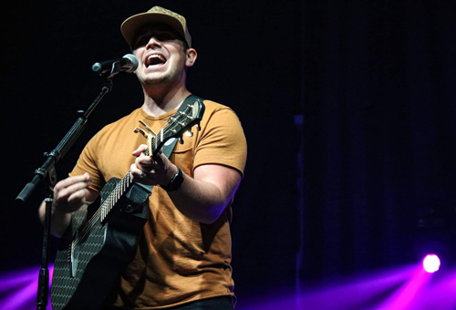 Zachary Freedom playing guitar and singing