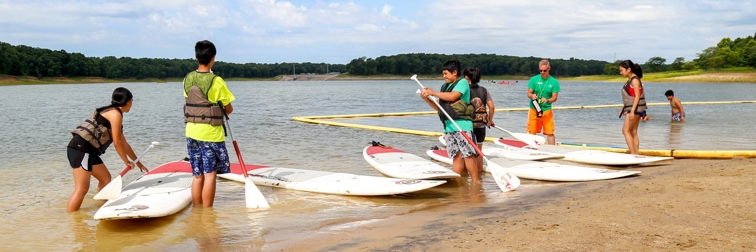 Getting ready to go paddle-boarding on Rathbun Lake on the beach in front of Honey Creek Resort