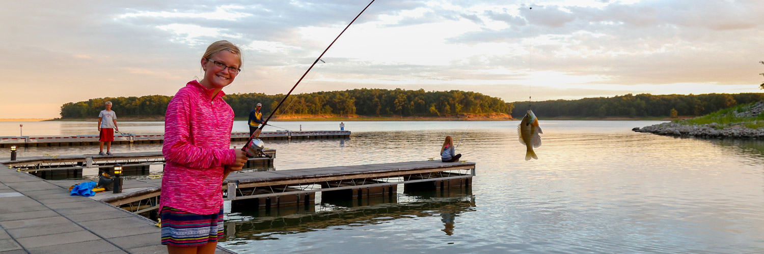 A guest at Honey Creek Resort catching a fish