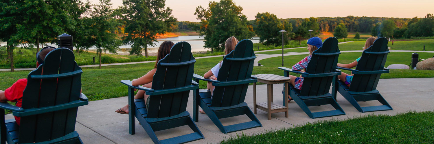 Honey Creek Resort guests lounging in Adirondack chairs