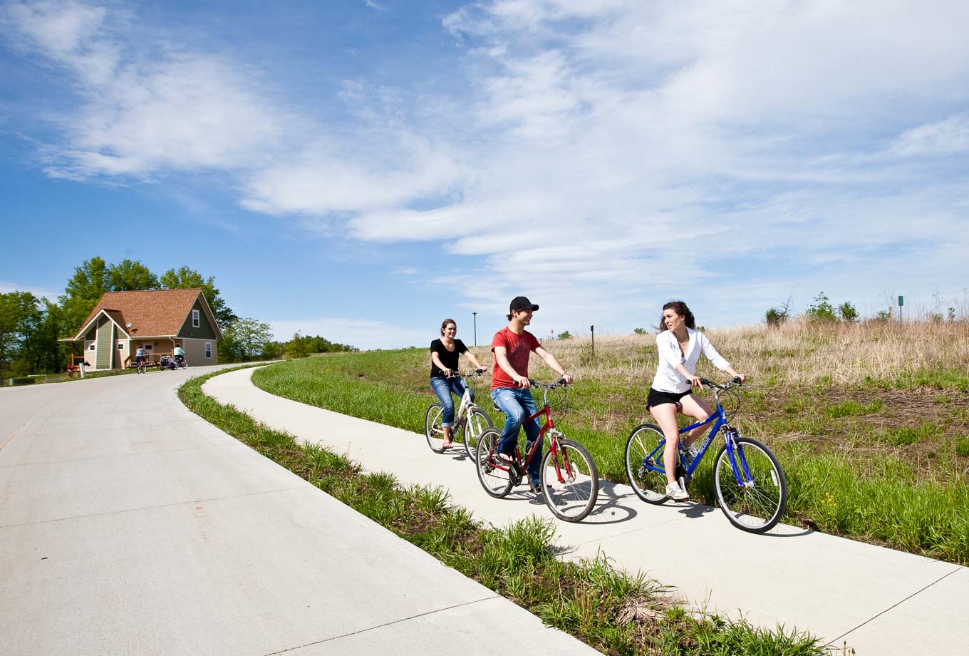 Biking on the trails in front of a cottage at Honey Creek Resort with rental bikes
