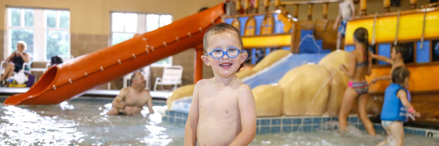 Kids playing in the indoor water park, Buccaneer Bay, at Honey Creek Resort