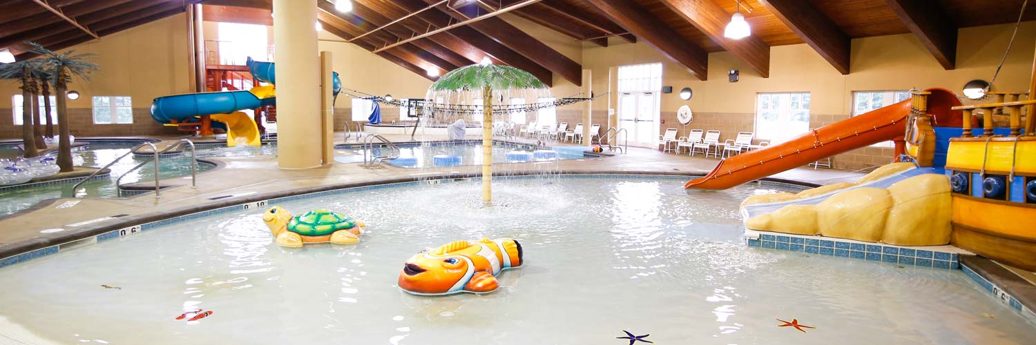 Fun indoor water park play at Buccanneer Bay in Honey Creek Resort