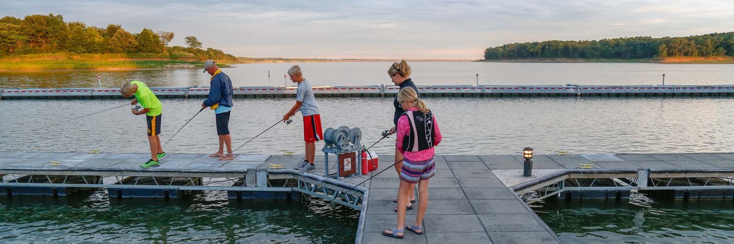 Family enjoys fishing on Rathbun Lake from the marina docks at Honey Creek Resort
