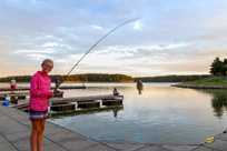 A girl enjoys fishing on Rathbun Lake from the marina docks at Honey Creek Resort