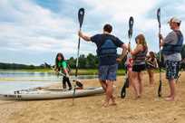 A group of friends participate in a kayak class along Rathbun Lake at Honey Creek Resort