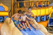 Kids get ready to go down a water slide at Buccaneer Bay, the Indoor water park at Honey Creek Resort