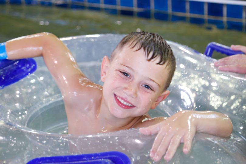 Child floats in an inner tube in the water at the indoor water park, Bucanneer Bay, at Honey Creek Resort