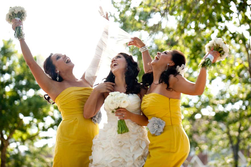 Bride and bridesmaids in a sunny yellow-themed wedding at Honey Creek Resort