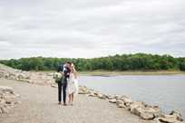 Bride and groom share a romantic moment on one of the trails near Honey Creek next to Rathbun Lake