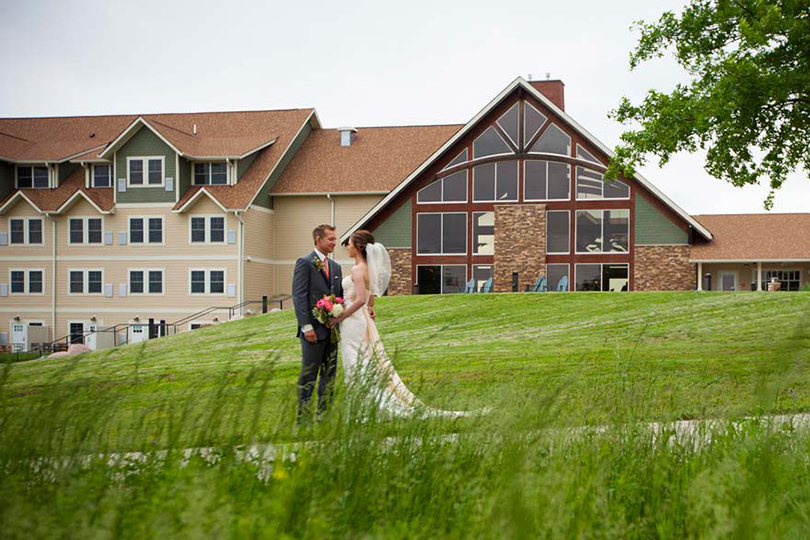 Bride and groom enjoy a quiet moment during their wedding with Honey Creek Resort in the background