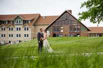 Bride and groom enjoy a quiet moment during their wedding with Honey Creek Resort in the background