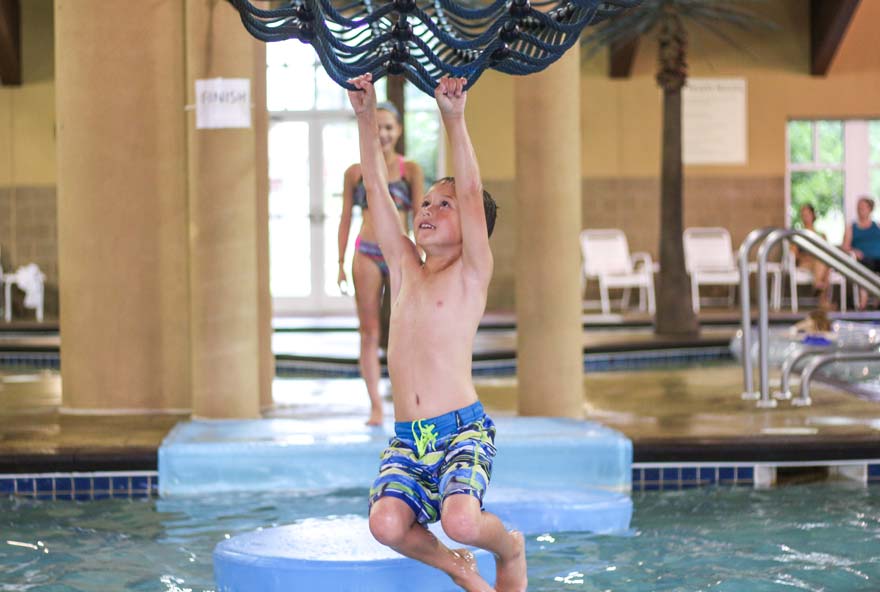 A kid plays at Buccaneer Bay, Honey Creek Resort's indoor water park
