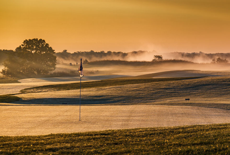 Golden morning light on a golf green at The Preserve on Rathbun Lake at Honey Creek Resort