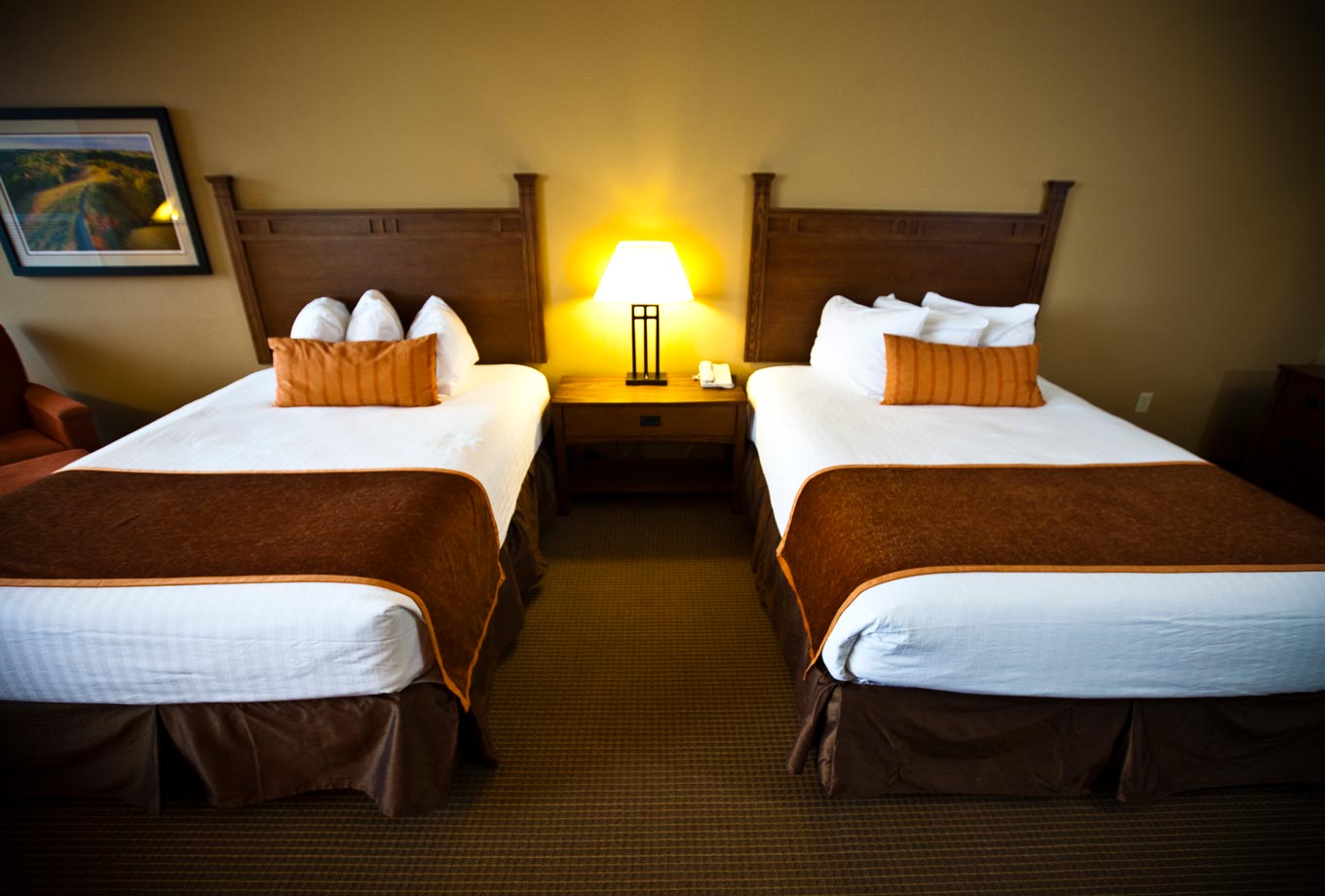 Two queen-size beds are featured in guest rooms at Honey Creek Resort's the Lodge on Rathbun Lake