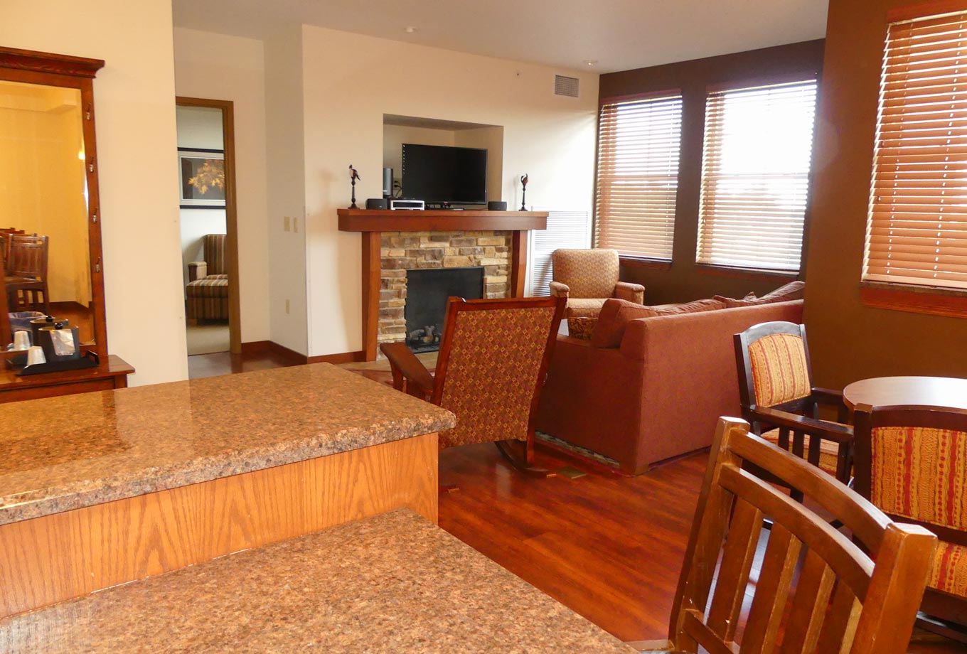 Presidential King Suites in the lodge at Honey Creek Resort feature a large sitting area that includes a fireplace and TV