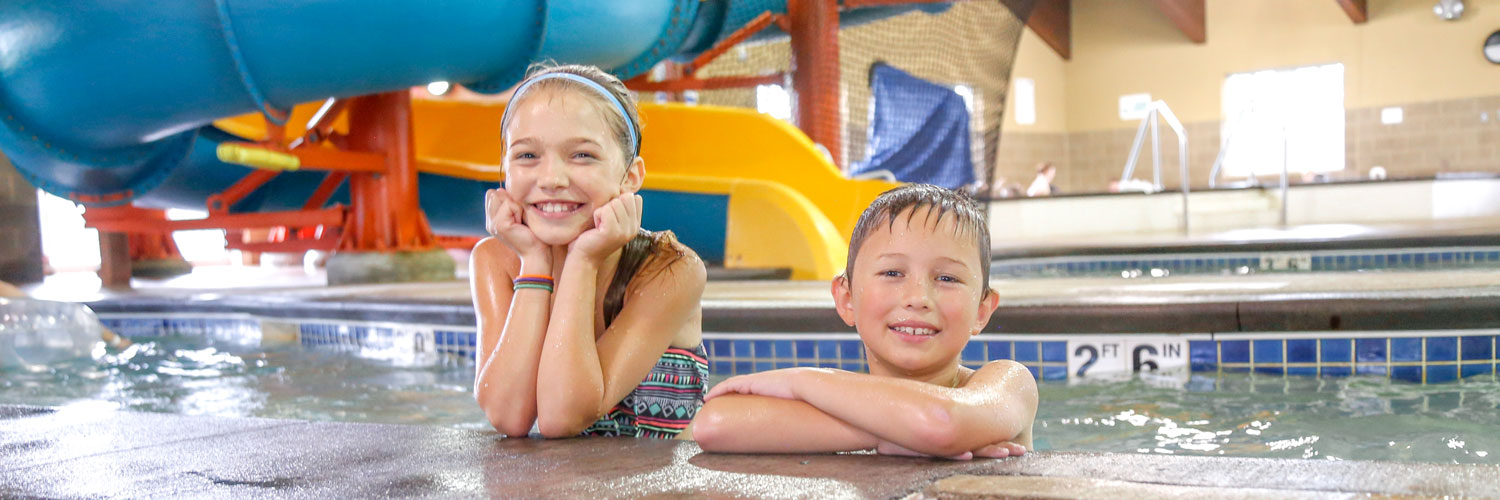 Brother and sister enjoying the Honey Creek Resort indoor pool and water park